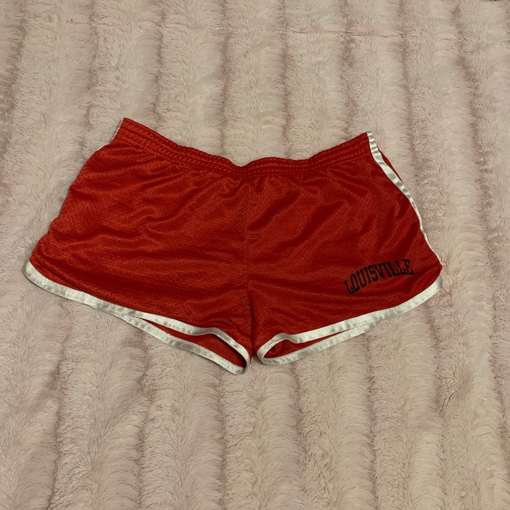 Red running shorts with Louisville Cards logo
